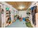 Well-lit basement storage area featuring organized shelves and an array of water sports equipment and gear at 619 E Erie Ave, Folly Beach, SC 29439