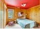 Stylish bedroom featuring wood paneling, vibrant lighting, and a comfortable bed at 619 E Erie Ave, Folly Beach, SC 29439