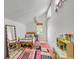 Bright bedroom with a sloped ceiling, neutral walls, and a colorful rug at 619 E Erie Ave, Folly Beach, SC 29439