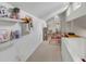 Bright bonus room featuring carpeted floors, white walls, floating shelves, and desk area at 619 E Erie Ave, Folly Beach, SC 29439