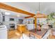 Spacious kitchen with a center island, stainless steel appliances, and wood beam accents, adjacent to the dining area at 619 E Erie Ave, Folly Beach, SC 29439