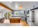 Modern kitchen with stainless steel appliances, a center island, and ample counter space, offering seamless indoor-outdoor living at 619 E Erie Ave, Folly Beach, SC 29439
