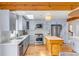 Updated kitchen features stainless steel appliances, white cabinets, and a stylish center island for meal preparation at 619 E Erie Ave, Folly Beach, SC 29439