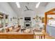 Spacious living room with skylights, hardwood floors, fireplace, and comfortable seating arrangement at 619 E Erie Ave, Folly Beach, SC 29439