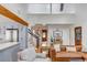 Bright and open floor plan connecting the living room, staircase, and kitchen with hardwood floors at 619 E Erie Ave, Folly Beach, SC 29439