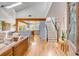 Inviting living room with vaulted ceilings, skylights, and hardwood floors leading to a modern kitchen at 619 E Erie Ave, Folly Beach, SC 29439