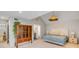 Spacious primary bedroom features high ceilings, unique light fixture and decorative wall hangings at 619 E Erie Ave, Folly Beach, SC 29439