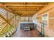 Cozy outdoor space features a hot tub with stone surround and wooden decking, perfect for relaxation and privacy at 619 E Erie Ave, Folly Beach, SC 29439