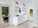 Charming bar area with white cabinets, open shelves, and a view of the backyard at 641 Cottage Landing Dr, Summerville, SC 29485