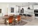 Open concept dining area with modern lighting, stainless steel appliances, and a spacious table at 641 Cottage Landing Dr, Summerville, SC 29485