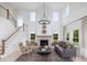 Bright living room with vaulted ceilings, large windows, fireplace, and open staircase at 641 Cottage Landing Dr, Summerville, SC 29485