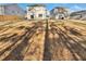 Backyard view featuring a grass area, new home construction, and a wood fence at 669 Silver Spruce St, Summerville, SC 29486