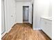 Bright bathroom featuring wood-look floors, walk-in closet and white cabinets at 669 Silver Spruce St, Summerville, SC 29486