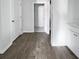Bright bathroom featuring wood-look floors, walk-in closet and white cabinets at 669 Silver Spruce St, Summerville, SC 29486