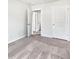 Bedroom with neutral carpet and multiple doors to bathroom and closets at 669 Silver Spruce St, Summerville, SC 29486
