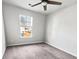 Bright bedroom with neutral carpet, ceiling fan, and window view at 669 Silver Spruce St, Summerville, SC 29486
