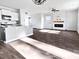 Open concept living space with wood floors, kitchen island, fireplace, and ample natural light at 669 Silver Spruce St, Summerville, SC 29486