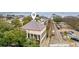 An aerial shot highlighting path to parking for a two-story home with manicured trees and a cobblestone street at 90 E Bay St, Charleston, SC 29401