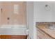 This bathroom features a bathtub with glass enclosure, neutral tile, and granite vanity at 90 E Bay St, Charleston, SC 29401