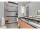 Bathroom with double sink, shower with accent tiles and stone floors at 90 E Bay St, Charleston, SC 29401