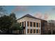 An elegant building with black shutters and neutral stone against a vivid sunset sky at 90 E Bay St, Charleston, SC 29401