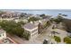 An aerial view of a stately two-story home near the water, featuring dark shutters and cobblestone streets at 90 E Bay St, Charleston, SC 29401