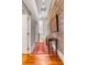 Hallway features hardwood floors, brick wall and console table at 90 E Bay St, Charleston, SC 29401