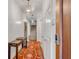 Hallway with hardwood floors, a decorative rug, stylish lighting, a staircase, and white wood-paneled walls at 90 E Bay St, Charleston, SC 29401