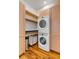 Convenient laundry room with stacked washer and dryer, storage cabinets, and a folding area at 90 E Bay St, Charleston, SC 29401