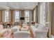 Comfortable living room featuring hardwood floors, large windows, and a cozy seating area, connecting to the dining space at 90 E Bay St, Charleston, SC 29401
