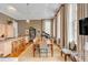Open-concept living and dining area with modern lighting, piano, and a large dining table, with an eat-in kitchen island at 90 E Bay St, Charleston, SC 29401