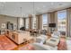 Open-concept design featuring a modern kitchen island, dining area, and comfortable living room with large windows at 90 E Bay St, Charleston, SC 29401