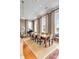 Elegant living and dining area with large windows, a piano, and a spacious dining table, bathed in natural light at 90 E Bay St, Charleston, SC 29401