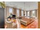 A spacious living room with a piano, dining table, kitchen island, hardwood floors, and natural lighting at 90 E Bay St, Charleston, SC 29401
