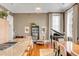 Stylish kitchen flowing into a living area, showcasing granite counters, seating, and a grand piano at 90 E Bay St, Charleston, SC 29401