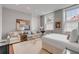 Well-lit main bedroom featuring a cozy sitting area, a comfortable bed, and neutral decor at 90 E Bay St, Charleston, SC 29401