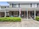 Charming brick townhouse with an American flag and a well-manicured front yard at 925 Dills Bluff Rd # 34, Charleston, SC 29412