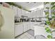 Bright kitchen with white cabinets, contrasting backsplash, and tiled floors at 925 Dills Bluff Rd # 34, Charleston, SC 29412