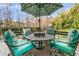 A large, round outdoor table with umbrella with chairs, perfect for outdoor relaxation and enjoyment at 941 Law Ln, Mount Pleasant, SC 29464