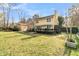 Backyard with a well-maintained lawn, mature trees, and a deck perfect for relaxation and entertainment at 941 Law Ln, Mount Pleasant, SC 29464