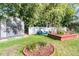 Cozy backyard setting features an outdoor shed, charming seating area and verdant vegetation at 941 Law Ln, Mount Pleasant, SC 29464