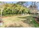 A wide shot of the back yard featuring a well-manicured lawn and beautiful trees at 941 Law Ln, Mount Pleasant, SC 29464