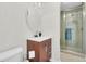 Bathroom showcasing a wood vanity, oval mirror, and glass-enclosed shower with tiled walls at 941 Law Ln, Mount Pleasant, SC 29464