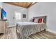 Inviting bedroom showcasing a bed, wooden ceiling, and a door that brings in natural light at 941 Law Ln, Mount Pleasant, SC 29464