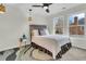 Cozy bedroom features a bed, ceiling fan, and a natural accent rug, all enhanced by natural light from the windows at 941 Law Ln, Mount Pleasant, SC 29464