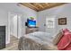Comfortable bedroom featuring a bed, TV on a wooden cabinet, and an exterior door that fills room with light at 941 Law Ln, Mount Pleasant, SC 29464