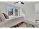 Comfortable bedroom features a cozy bed, complemented by neutral tones and natural light from the windows at 941 Law Ln, Mount Pleasant, SC 29464