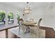 Bright dining room featuring a modern chandelier and access to an outdoor deck at 941 Law Ln, Mount Pleasant, SC 29464