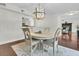 Elegant dining space with round table, seating, and a modern chandelier, open to the kitchen and living room at 941 Law Ln, Mount Pleasant, SC 29464