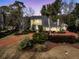 Stunning home with a long, curved driveway surrounded by mature trees and landscaping at 941 Law Ln, Mount Pleasant, SC 29464